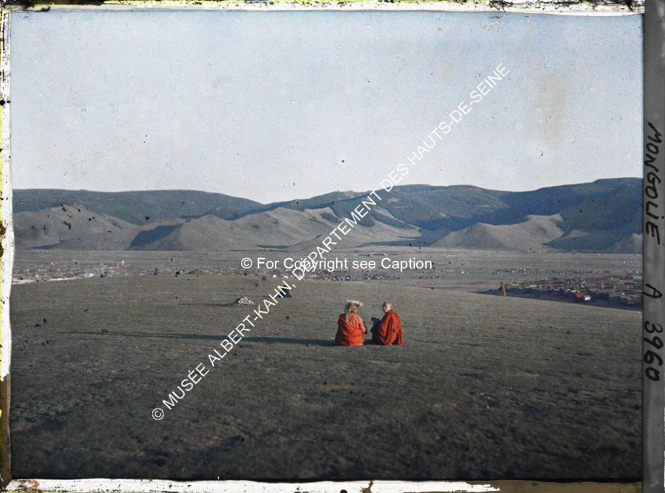 Monks sitting at Tasganii ovoo between Züün khüree and Gandan. Musée Albert-Kahn. A3960. Photo by St